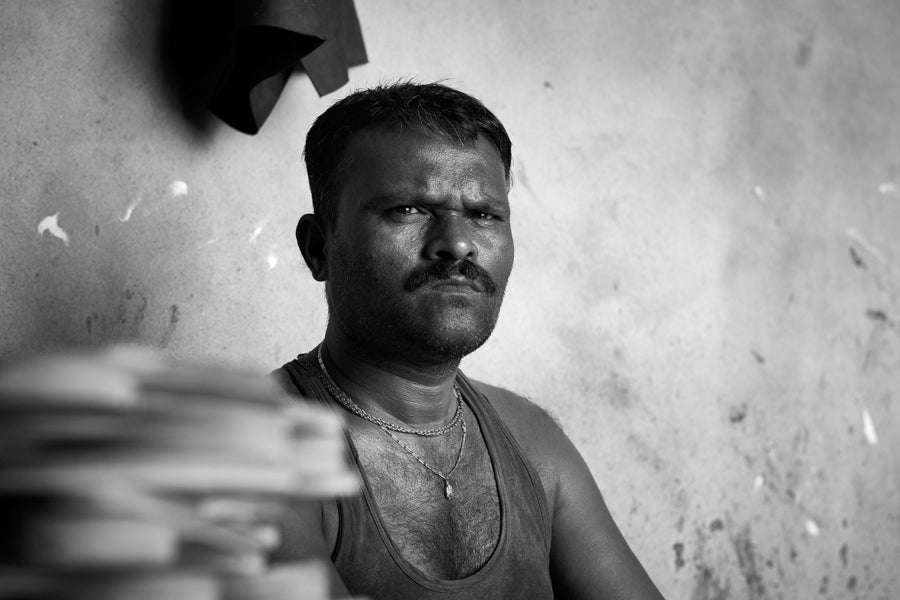 Hand-stitched Kolhapuri chappal with the artisan who made it, Kolhapur district, Maharashtra